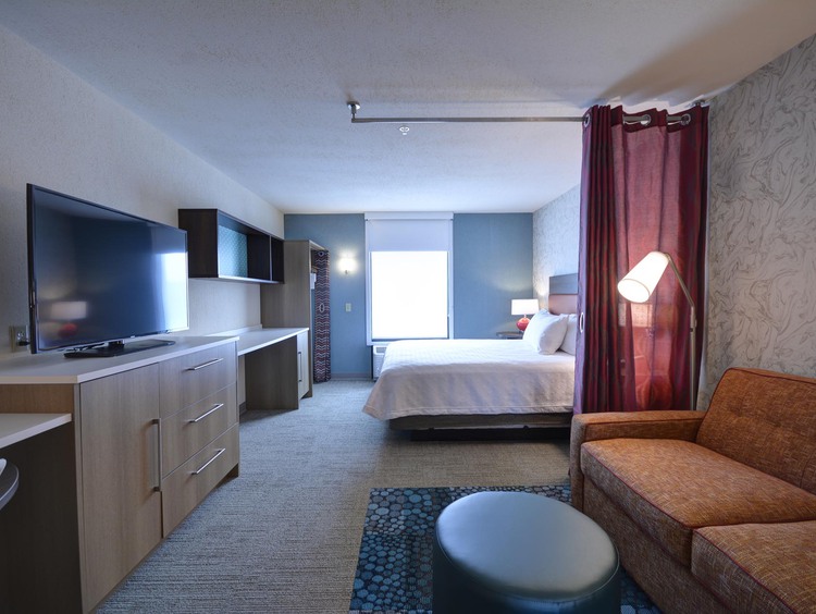 1 queen room with sofa and tv