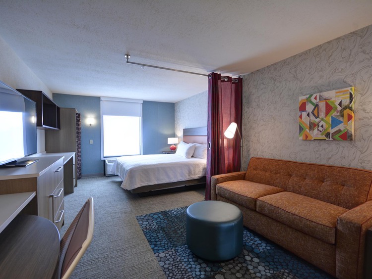 1 queen bed with sofa and tv